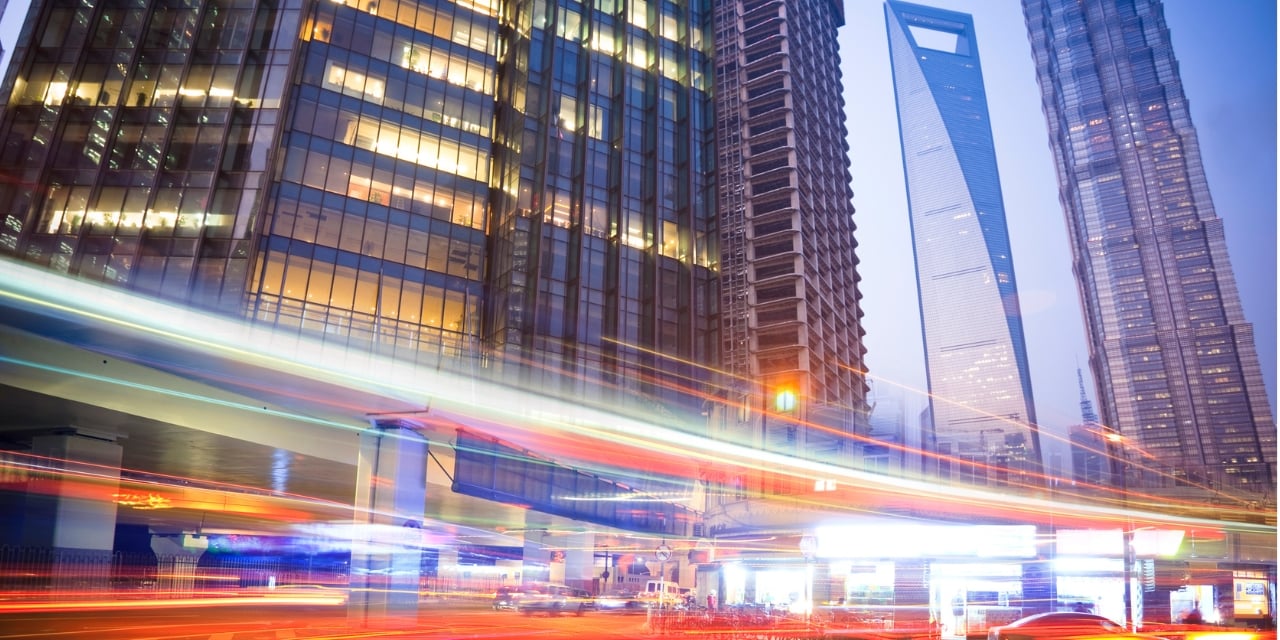 Modern hotel building in the background with cars driving in front in an abstract presentation