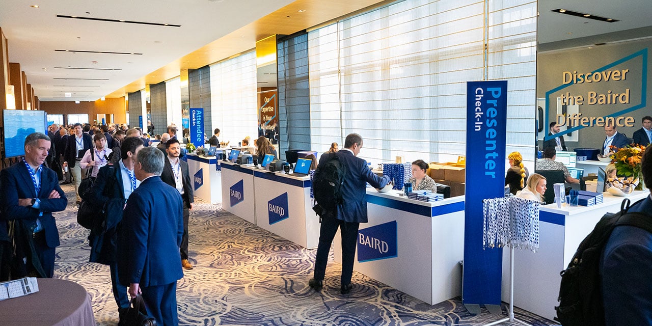 Attendees in the check-in area of a Silver LakeConference