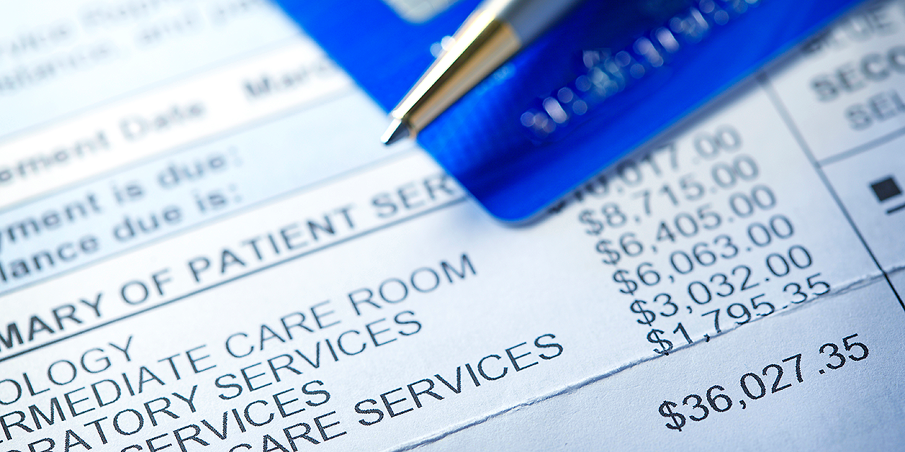 Medical bill showing itemized charges and total cost, with credit card ready for payment.